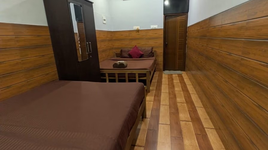 Cosy private room interior with wooden walls and bamboo flooring at Holistic Eco-Resort