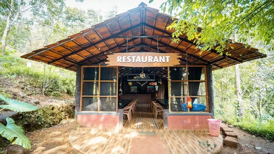Exterior of Mom's Kitchen restaurant nestled in the jungle at Holistic Eco-Resort
