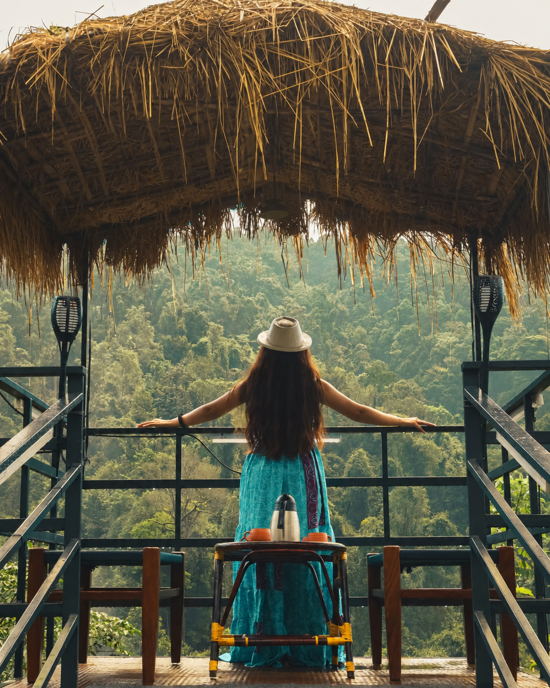 A-frame cabin with string lights and rattan chairs surrounded by lush greenery at Holistic Eco-Resort