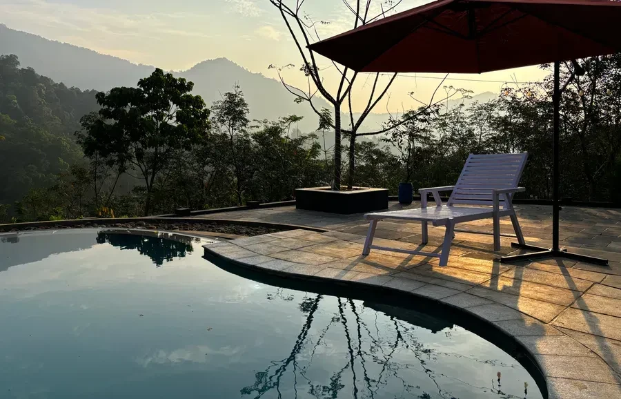 Infinity pool with mountain views at sunrise