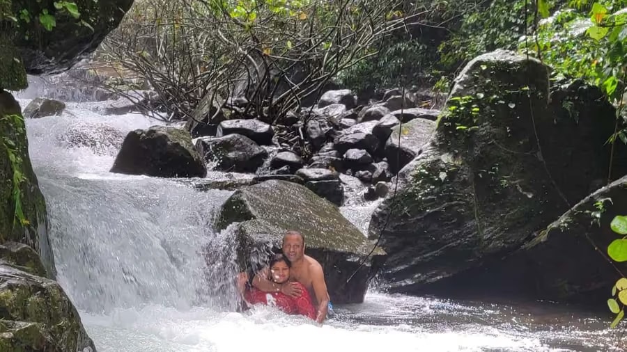 Family swimming at the private waterfall