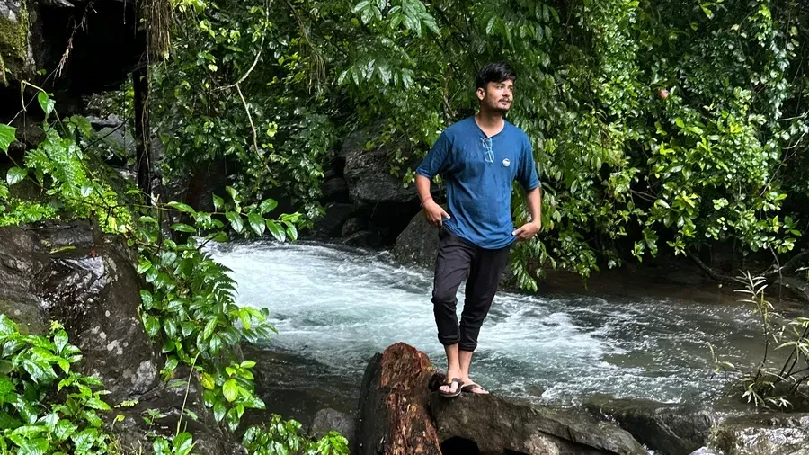 Guest standing by the jungle stream